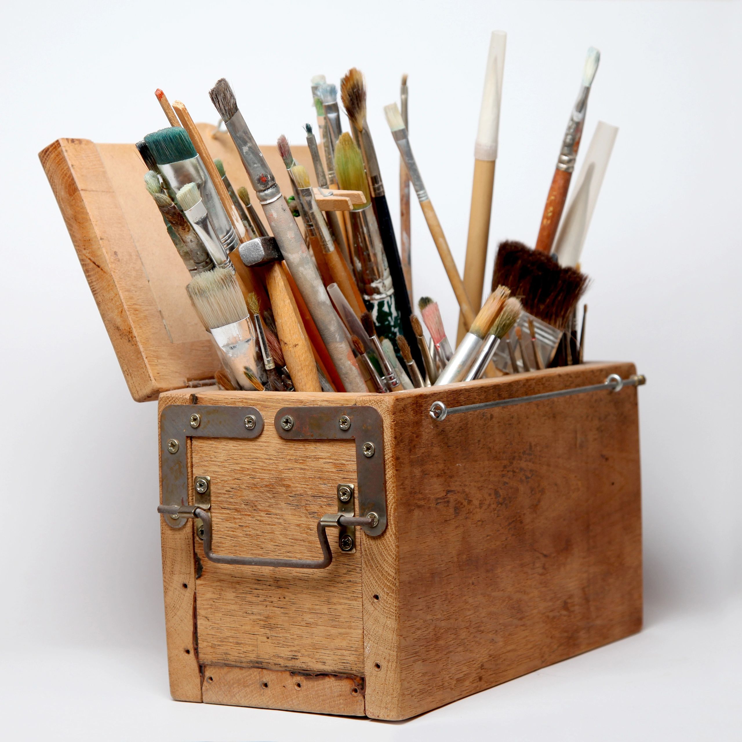 Artist brushes representing the studio's creative materials